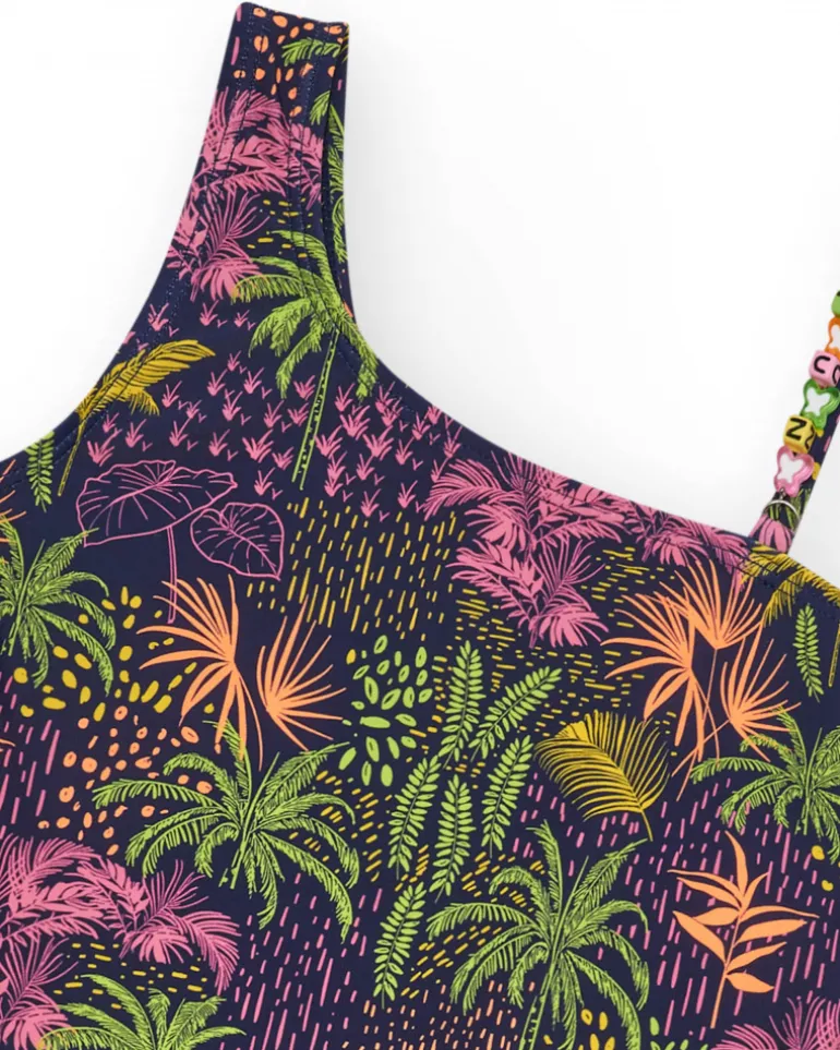 Bañador para niña en azul marino con diseño asimétrico y estampado tropical