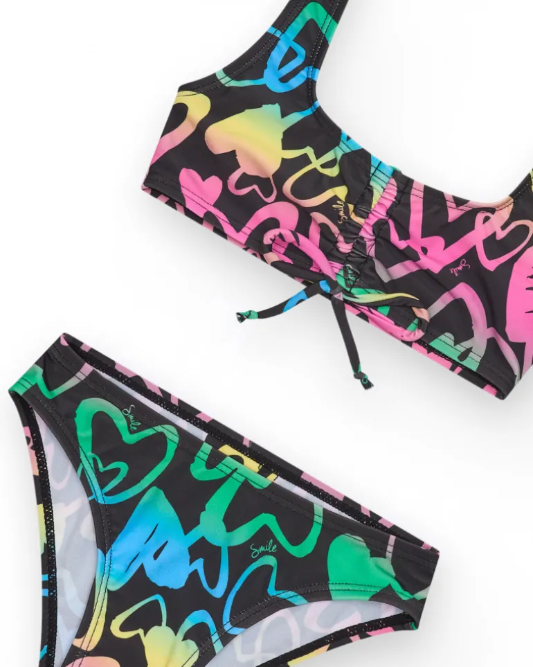 Bikini para niña en negro con corazones estampados y lazo decorativo