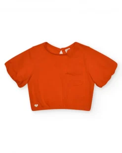Camiseta naranja para niña con flor y mangas abullonadas
