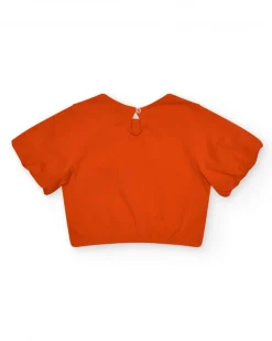 Camiseta naranja para niña con flor y mangas abullonadas