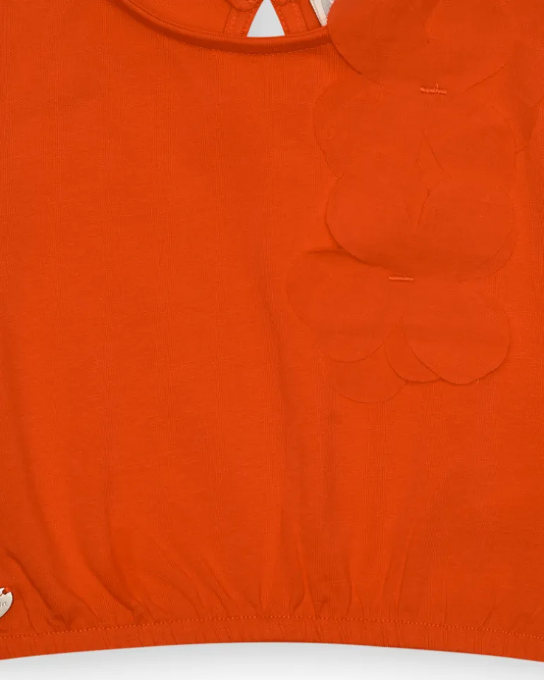 Camiseta naranja para niña con flor y mangas abullonadas