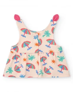 Conjunto crema para niña con blusa de paraguas y shorts rosa con volantes