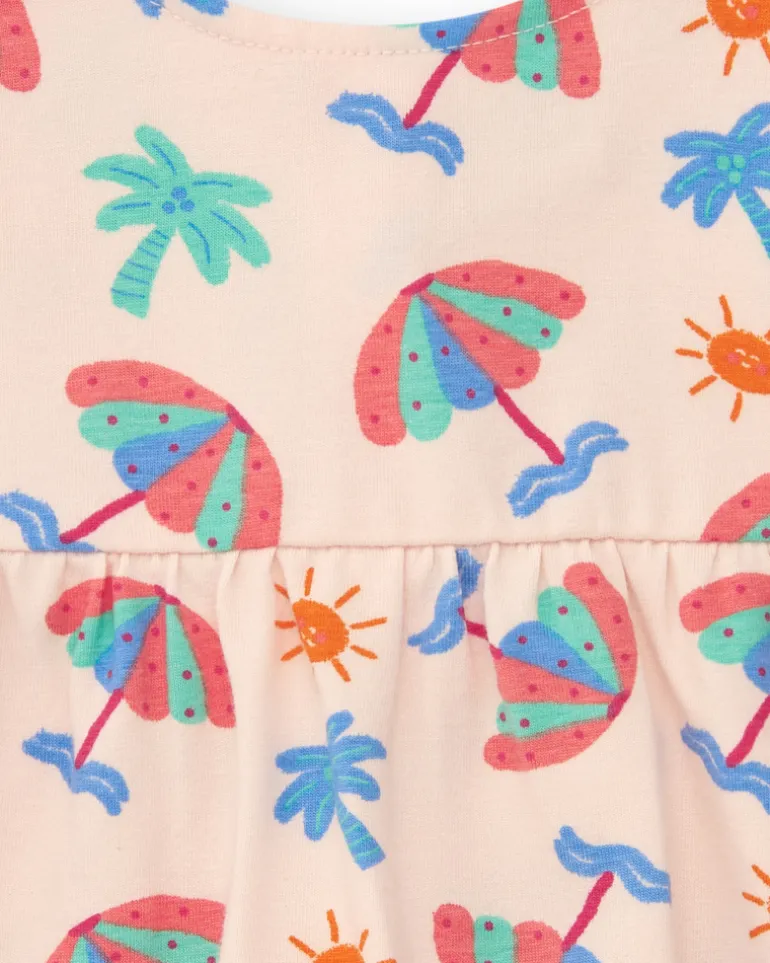 Conjunto crema para niña con blusa de paraguas y shorts rosa con volantes