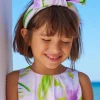Diadema para niña en tonos lilas con lazo decorativo.