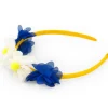 Diadema rígida para niña en amarillo con flores azules y blancas
