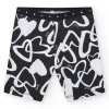 Legging ciclista para niña en negro con corazones estampados y cintura decorada con tachuelas