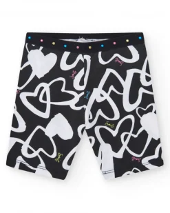 Legging ciclista para niña en negro con corazones estampados y cintura decorada con tachuelas