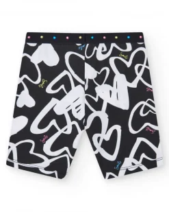 Legging ciclista para niña en negro con corazones estampados y cintura decorada con tachuelas