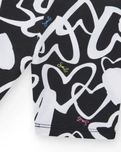 Legging ciclista para niña en negro con corazones estampados y cintura decorada con tachuelas