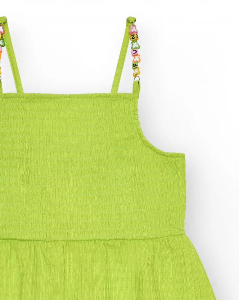 Mono para niña en verde con tirantes y detalles multicolor