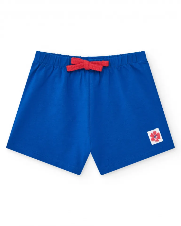 Pantalón corto para niña en azul con cintura elástica y lazo rojo