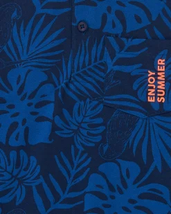 Polo para niño en azul con estampado tropical y bordado