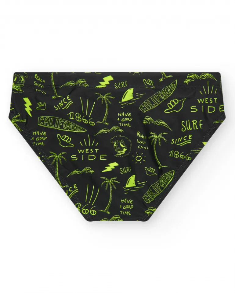 Slip de baño para niño en negro con estampado surfero y cordón flúor.
