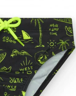 Slip de baño para niño en negro con estampado surfero y cordón flúor.