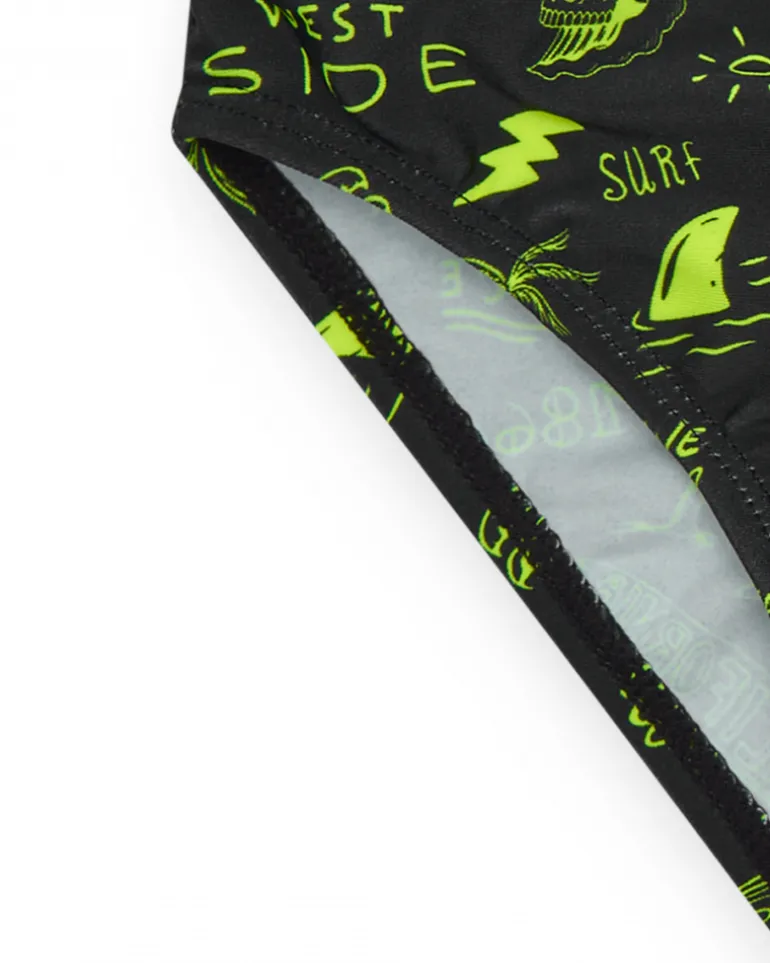 Slip de baño para niño en negro con estampado surfero y cordón flúor.