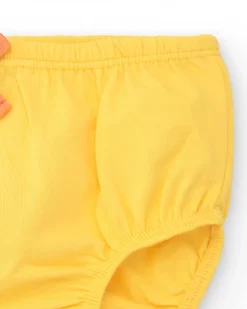 Vestido melocotón para niña con estampado floral y tirantes anudados