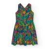 Vestido para niña con estampado tropical multicolor y tirantes cruzados.