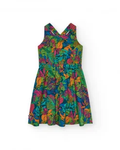 Vestido para niña con estampado tropical multicolor y tirantes cruzados.