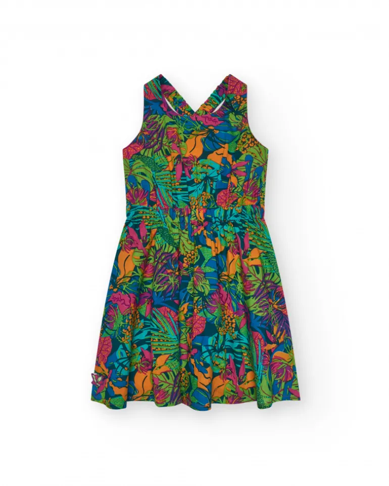 Vestido para niña con estampado tropical multicolor y tirantes cruzados.