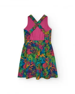 Vestido para niña con estampado tropical multicolor y tirantes cruzados.