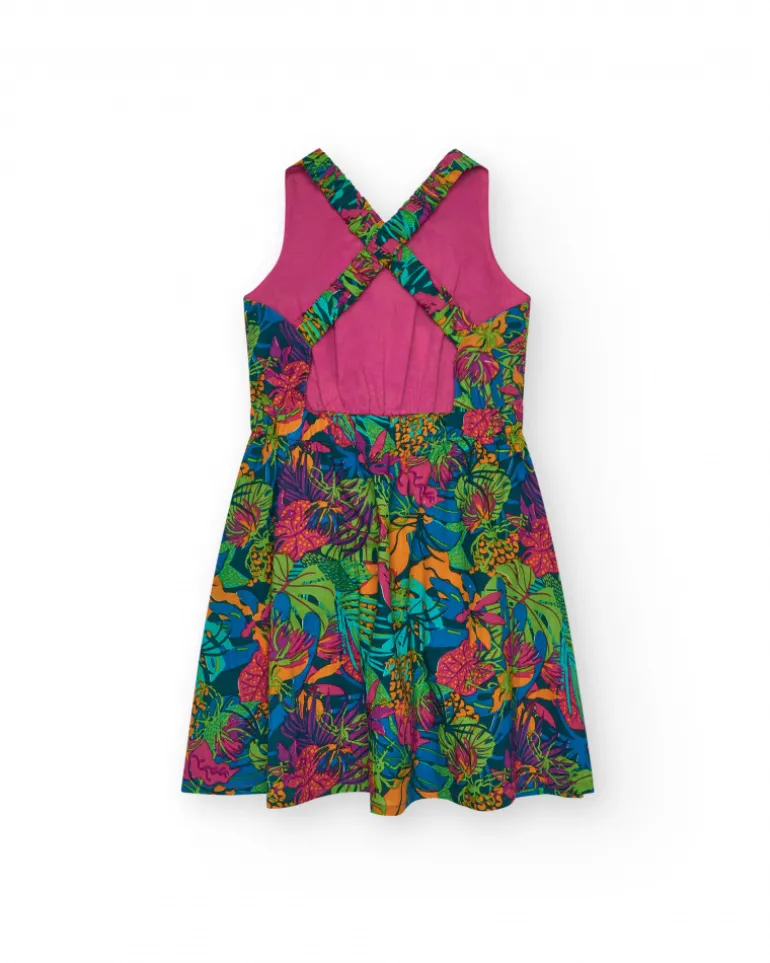 Vestido para niña con estampado tropical multicolor y tirantes cruzados.