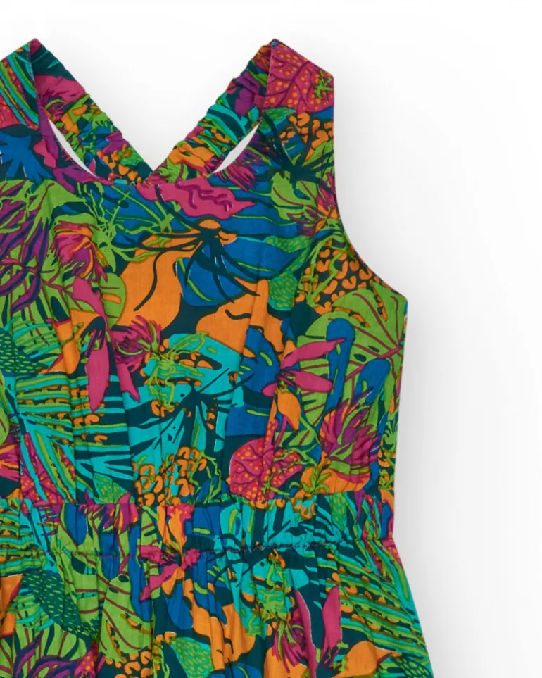 Vestido para niña con estampado tropical multicolor y tirantes cruzados.