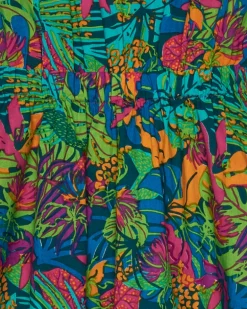 Vestido para niña con estampado tropical multicolor y tirantes cruzados.