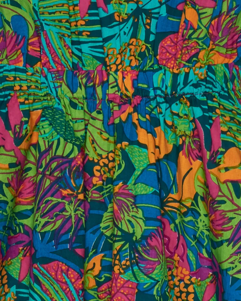 Vestido para niña con estampado tropical multicolor y tirantes cruzados.
