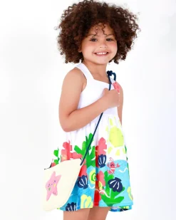 Vestido para niña en blanco con tirantes cruzados y falda floral